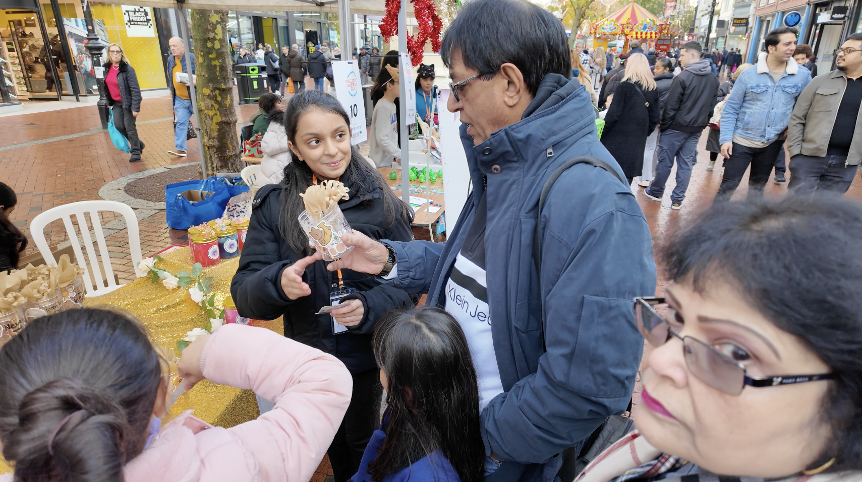 A young entrepreneurs sells her handmade products at the Reading Children's Business Fair